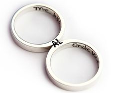 two wedding rings with the names on them