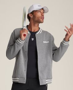 Suit up in timeless sport style. An easy layer to snap over a polo or tee, the Hudson Bomber Jacket brings a touch of luxury to the court. It's made of premium tricot fabric that feels comfortably breathable and wonderfully soft against your skin. Wilson branding accents this bomber, nodding to a hundred-year legacy on the court. | Wilson Hudson Bomber Jacket Sports Outerwear With Ribbed Cuffs, Fall Track Jacket With Logo And Long Sleeves, Sporty Track Jacket With Ribbed Cuffs For Fall, Cotton Sports Track Jacket For Spring, Sports Outerwear With Ribbed Cuffs For Sports Season, Cotton Track Jacket For Spring Sports, Cotton Track Jacket With Ribbed Cuffs Athleisure, Relaxed Fit Athleisure Track Jacket With Ribbed Cuffs, Sporty Long Sleeve Track Jacket With Relaxed Fit