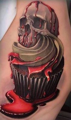 a woman's thigh with a cupcake and skull tattoo on the side,