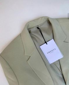 a green suit with a white tag on it