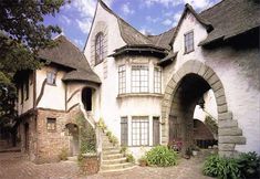 an old style house with arched windows and stone steps