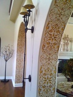 an ornate design on the side of a door in a house with wood flooring