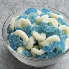 a glass bowl filled with blue and white candy