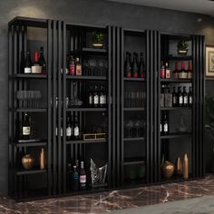 an empty bar with wine bottles and glasses on the shelves in front of it,