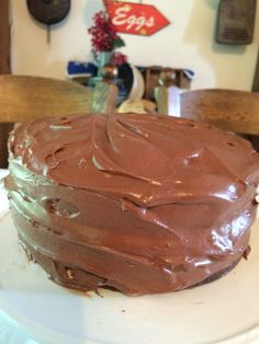 a chocolate cake sitting on top of a white plate