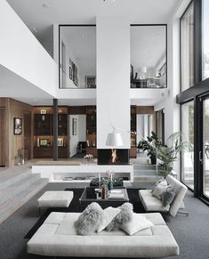 a living room filled with furniture and a fire place in the middle of a room