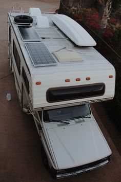 an rv with solar panels on the roof