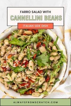 a white bowl filled with beans and greens on top of a yellow striped table cloth