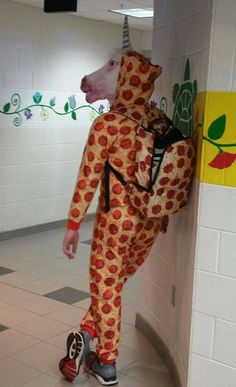 a man in a pizza suit is walking down the hallway