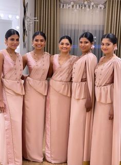 the bridesmaids are posing for a photo in their pink dresses and shawls