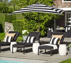 an article in the magazine features lounge chairs and umbrellas