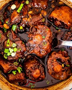 a pot filled with meat and vegetables covered in sauce