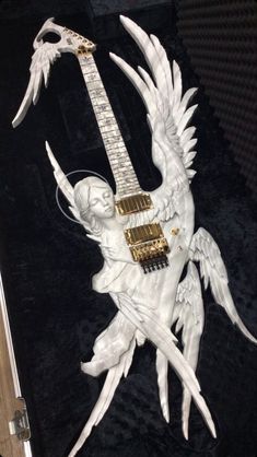 a white guitar with angel wings on it