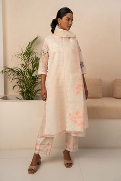 Ivory three quarter sleeve kurta with pink square and floral print. Paired with a coordinating pant and dupatta.
Components: 3
Pattern: Print
Type Of Work: Square,Floral
Neckline: Round Neck
Sleeve Type: Three Quarter Sleeves
Fabric: Organza, Chanderi
Color: Ivory
Other Details: 
Scallop trim, floral print dupatta
Note: Inner worn by the model is not for sale
Occasion: Mehendi and Haldi,Work - Aza Fashions Lavender Shirt, Organza Jacket, Puff Sleeves Dress, Lavender Tops, Layered Tunic, Gathered Dress, Indian Fashion Designers, Kurta With Pants, Silk Pants