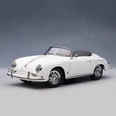 a white model car on a gray background