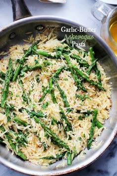 asparagus and parmesan pasta in a skillet on a marble table