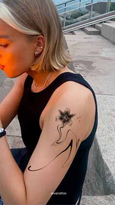 a woman with a flower tattoo on her arm