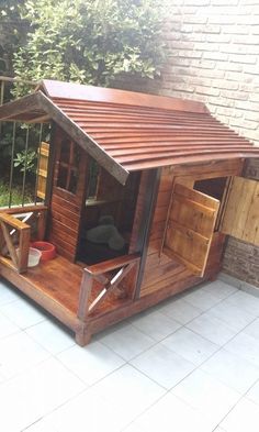 a small wooden shed with a door open