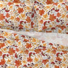 an orange and white floral print sheet set with matching pillow cases on top of each other