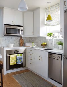 a kitchen with white cabinets and stainless steel appliances