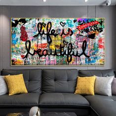 a living room filled with furniture and a large painting on the wall above it that says hello beautiful