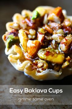 a bowl filled with pasta and vegetables on top of a wooden table next to text that reads easy baki lava cups gimme some oven