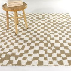 a brown and white area rug with a wooden table on the floor next to it