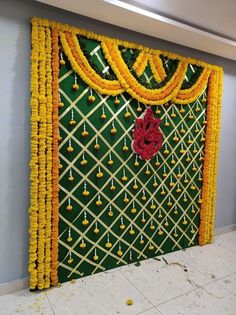 the wall is decorated with yellow and red garlands on it's sides, along with flowers