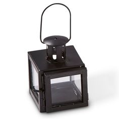 a small black lantern with a handle on it's side and a light inside