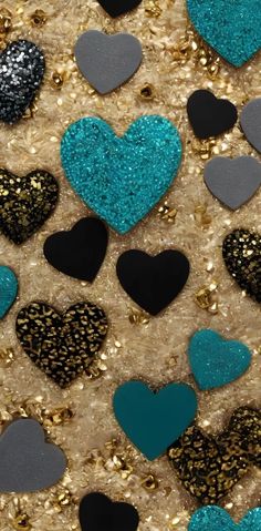 many different colored hearts are arranged in the shape of heart shapes on a gold and black background