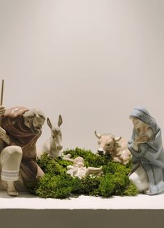 the nativity scene includes figurines of animals and people