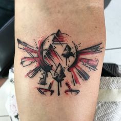 a tattoo on the leg of a person with an arrow and sun in the background