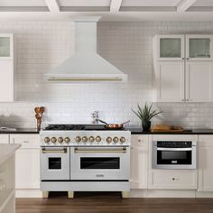 a white stove top oven sitting inside of a kitchen