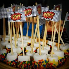 the cupcakes are decorated with candles and pop signs