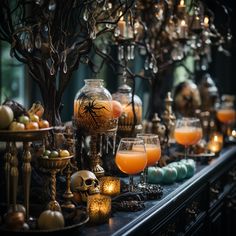 a table topped with lots of different types of halloween decorations and candles on top of it