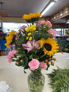 a vase filled with lots of flowers on top of a table