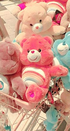 a shopping cart filled with lots of pink and blue teddy bears