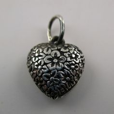 "This sterling silver, two-sided Solid Puffy Heart Charm Number 75 (Floral Heart) features a repeating design of flowers.Marked, Sterling. Made by Brown County Silver. Vintage and in new, never worn condition. Approximately 30 years old. Available in sterling silver and sterling silver with 14k gold vermeil. 3/4\" high with jump ring. 1/2\" wide 2.4 grams approx. *Chain not included See more @ https://www.etsy.com/shop/brocosi" Silver Spiritual Heart Charm Necklace, Handmade Silver Double Heart Necklace, Silver Heart Necklace For Valentine's Day, Silver Open Heart Necklace With Charms, Silver Spiritual Heart Necklace For Valentine's Day, Spiritual Silver Heart Necklace For Valentine's Day, Silver Heart Necklace With Heart Beads, Handmade Silver Heart Necklace, Brown County