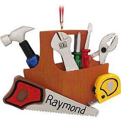 a christmas ornament with tools in it on a white background and the words raymond