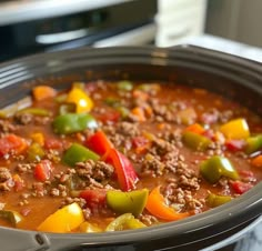 a crock pot filled with meat and vegetables