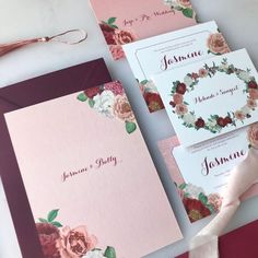 the wedding stationery is laid out on top of each other