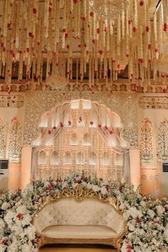 an elaborately decorated stage with flowers and chandelier