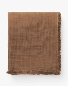 a brown blanket with fringes on it