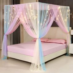 a pink and blue canopy bed with lights on it