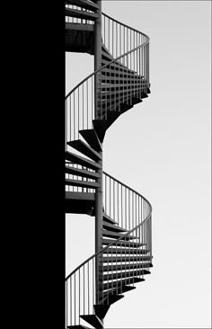 a black and white photo of a spiral staircase