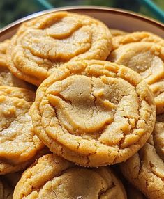 a plate full of cookies sitting on top of a table next to a blue cloth