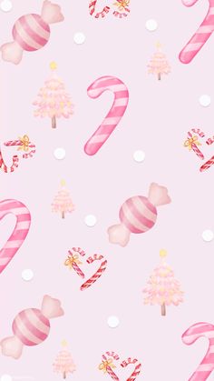 candy canes and christmas trees on a pink background