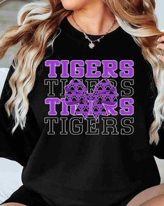 Looking for a fun and unique way to show off your Tigers spirit? Look no further than our Tigers DTF Transfer! This transfer is perfect for creating your own custom t-shirts, hoodies, and more. With our high-quality DTF transfer process, you can expect vibrant, full-color designs that will stand the test of time. This transfer features the Tigers DTF transfer in a bold and eye-catching coquette bow design. Our transfers are incredibly easy to apply using a standard heat press. Whether you're a s Black Graphic Print Sublimation Design For College, Black Cotton Sublimation Design For Game Day, Black Graphic Tee With Sublimation Text Print, Black Graphic Tee With Text Print Sublimation, Black Graphic Tee With Text Print, Black Slogan Tops For Fan Merchandise, Black Graphic Print Sweatshirt For Game Day, Black School Spirit T-shirt With Slogan, Trendy Black Tops With Lettering