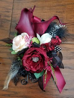 a bridal bouquet with feathers and flowers