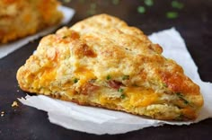 a cheesy biscuit sitting on top of a piece of paper